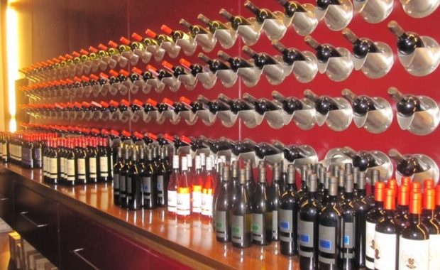 Beautiful display of wines no the shelf and onw the wall in a winery
